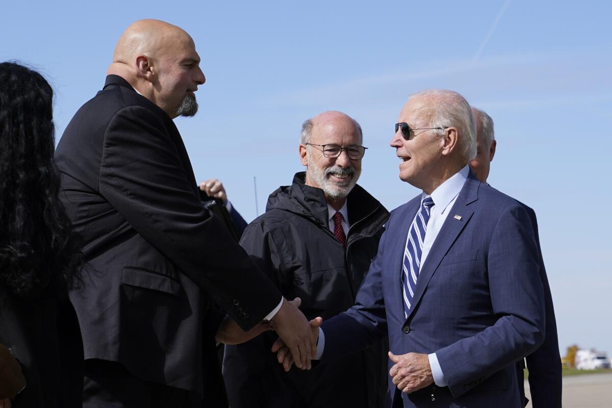 Pennsylvania Lt. Gov. John Fetterman shakes hands with Biden at airport.