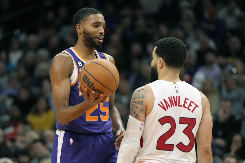 Phoenix Suns forward Mikal Bridges, left, talks to Toronto Raptors guard Fred VanVleet (23) during the second half of an NBA basketball game, Monday, Jan. 30, 2023, in Phoenix. (AP Photo/Rick Scuteri)