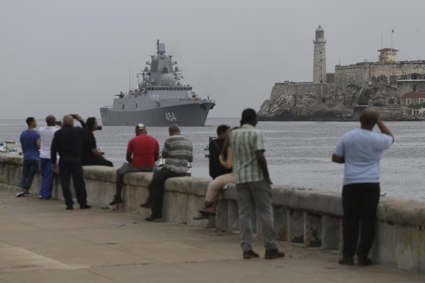 People watch the Russian Navy Admiral Gorshkov frigate arrive at the port of Havana, Cuba, Wednesday, June 12, 2024. A fleet of Russian warships reached Cuban waters on Wednesday ahead of planned military exercises in the Caribbean. (AP Photo/Ariel Ley)