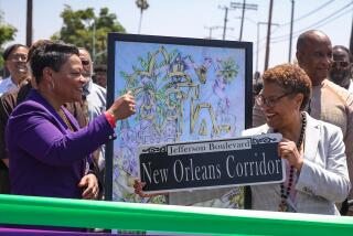 Los Angeles, CA - June 17: New Orleans Mayor LaToya Cantrell presents Los Angeles Mayor Karen Bass with a a New Orleans street sign and also commissioned artwork at the ribbon-cutting ceremony for the newly named, "New Orleans Corridor." on Saturday, June 17, 2023 in Los Angeles, CA. (Jason Armond / Los Angeles Times)
