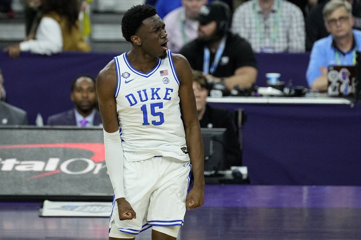 Duke center Mark Williams (15) celebrates his dunk against North Carolina during the first half of a college basketball game in the semifinal round of the Men's Final Four NCAA tournament, Saturday, April 2, 2022, in New Orleans. (AP Photo/Gerald Herbert)