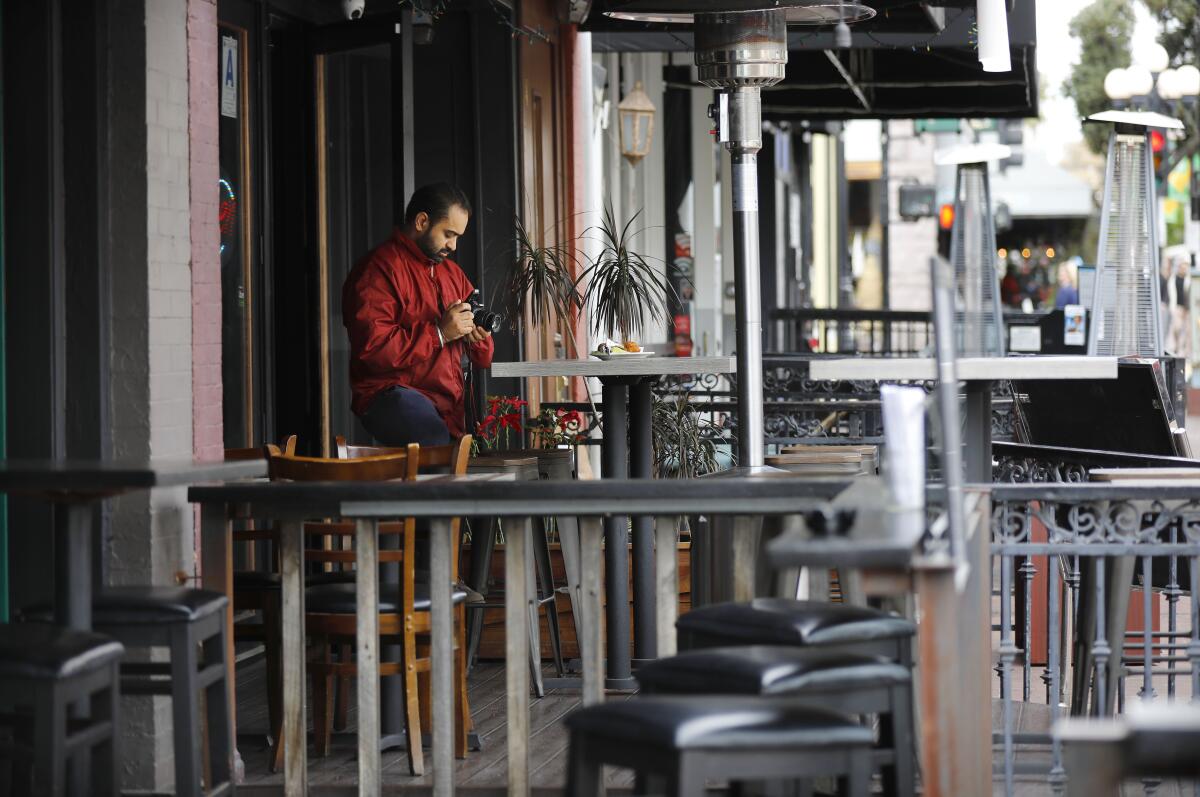 Surinder Singh, owner of Urban India restaurant in San Diego, with no customers in sight on Monday, a day before San Diego County banned dine-in eating at restaurants.