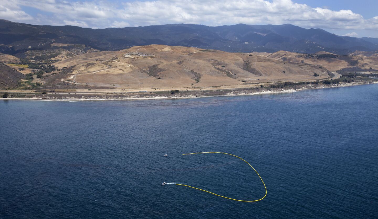 Oil booms are deployed offshore as cleanup and containment efforts continue on the beaches in Santa Barbara County.