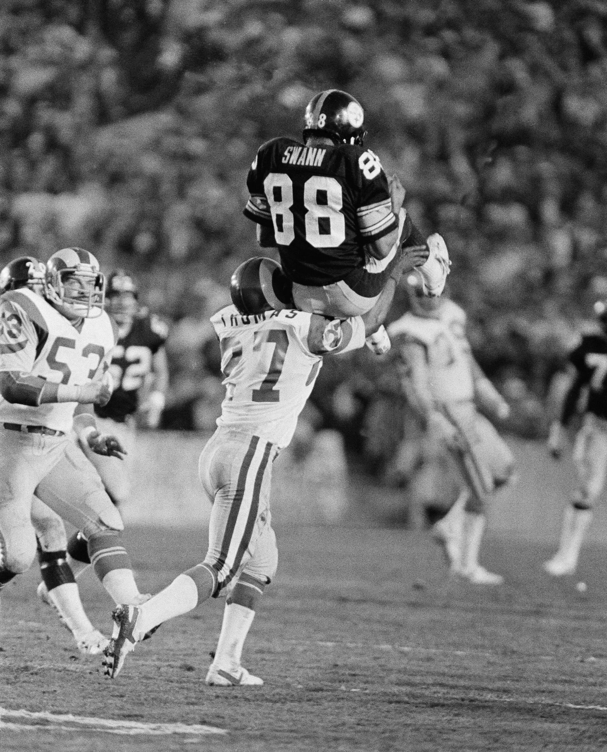 Pittsburgh Steelers receiver Lynn Swann (88) rests briefly on shoulder of Rams defender Pat Thomas (27) 