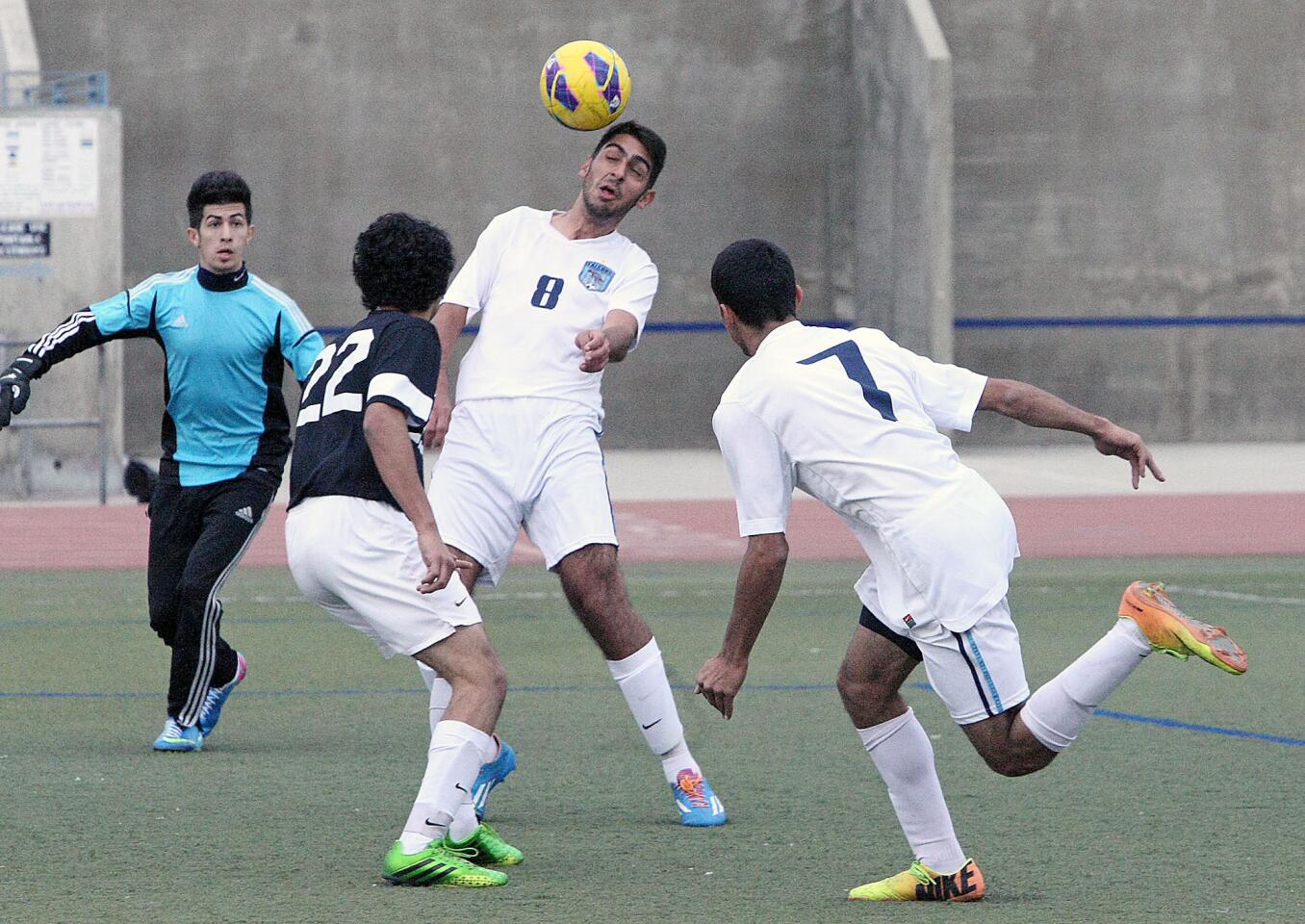 CV's Kevin Ginosian heads the ball into the net for for a goal against Glendale during a match at CV High on Tuesday, January 7, 2014.