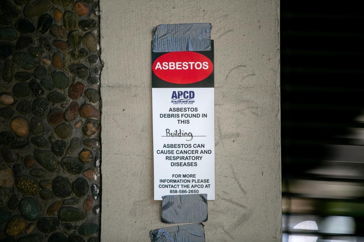 A sign warns of asbestos in the old Sempra Energy headquarters at 101 Ash St., pictured here on May 13, 2020.