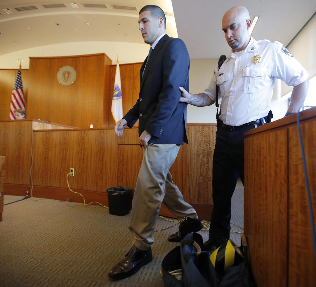 Aaron Hernandez, former player for the NFL's New England Patriots football team, is escorted from the witness stand after being questioned by Judge Susan Garsh during a court appearance at the Bristol County Superior Court in Fall River, Massachusetts October 9, 2013, in connection with the death of semi-pro football player Odin Lloyd in June. Hernandez, who was a rising star in the NFL before his arrest and release by the Patriots, has pleaded not guilty.