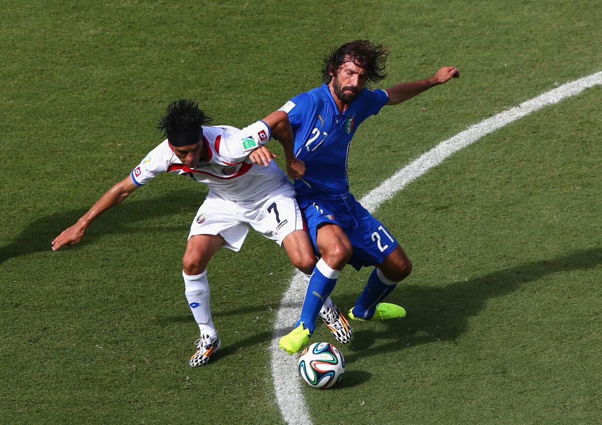 Christian Bolanos of Costa Rica and Andrea Pirlo of Italy compete for the ball during the 2014 FIFA World Cup Brazil match at Arena Pernambuco on Friday in Recife, Brazil.