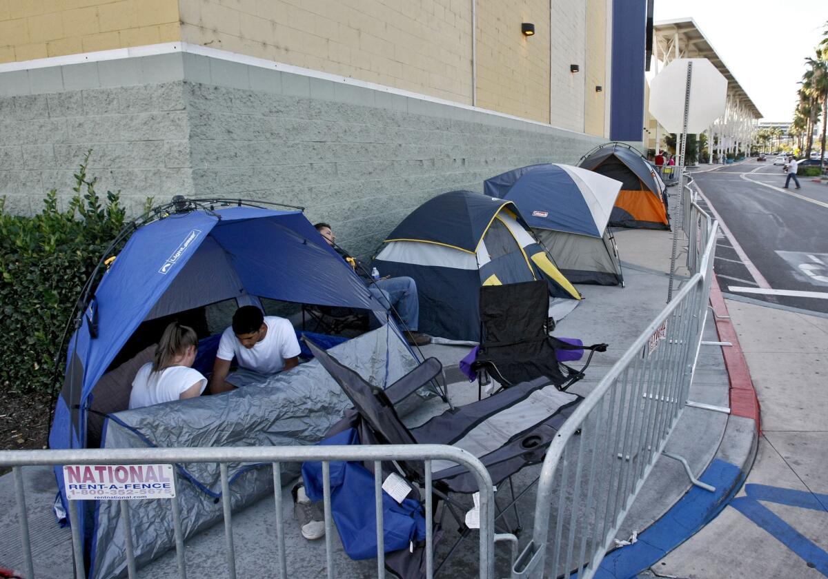 About 10 people with tents make an early line at the side of Best Buy as they wait for Black Friday, in Burbank on Tuesday, Nov. 26, 2013.