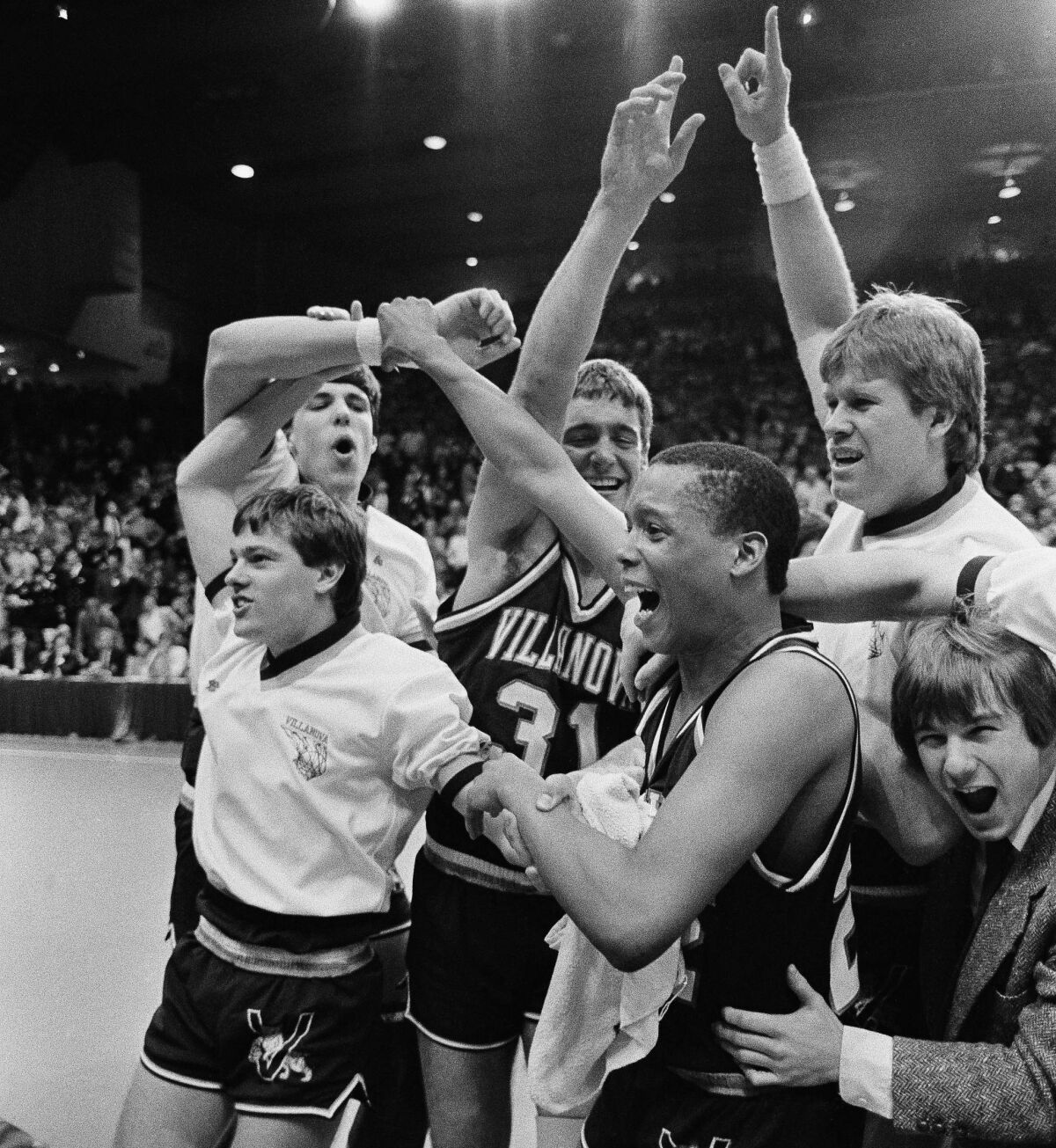 Villanova University players and coaches celebrate 59-55 NCAA tournament victory over Michigan.