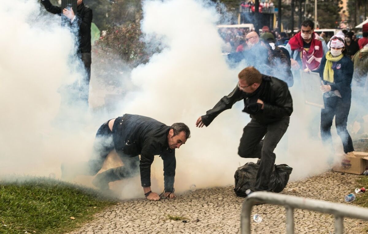 Teachers and police clash in downtown Curitiba, Brazil, on April 29, 2015 during protests by teachers seeking better wages and working conditions.