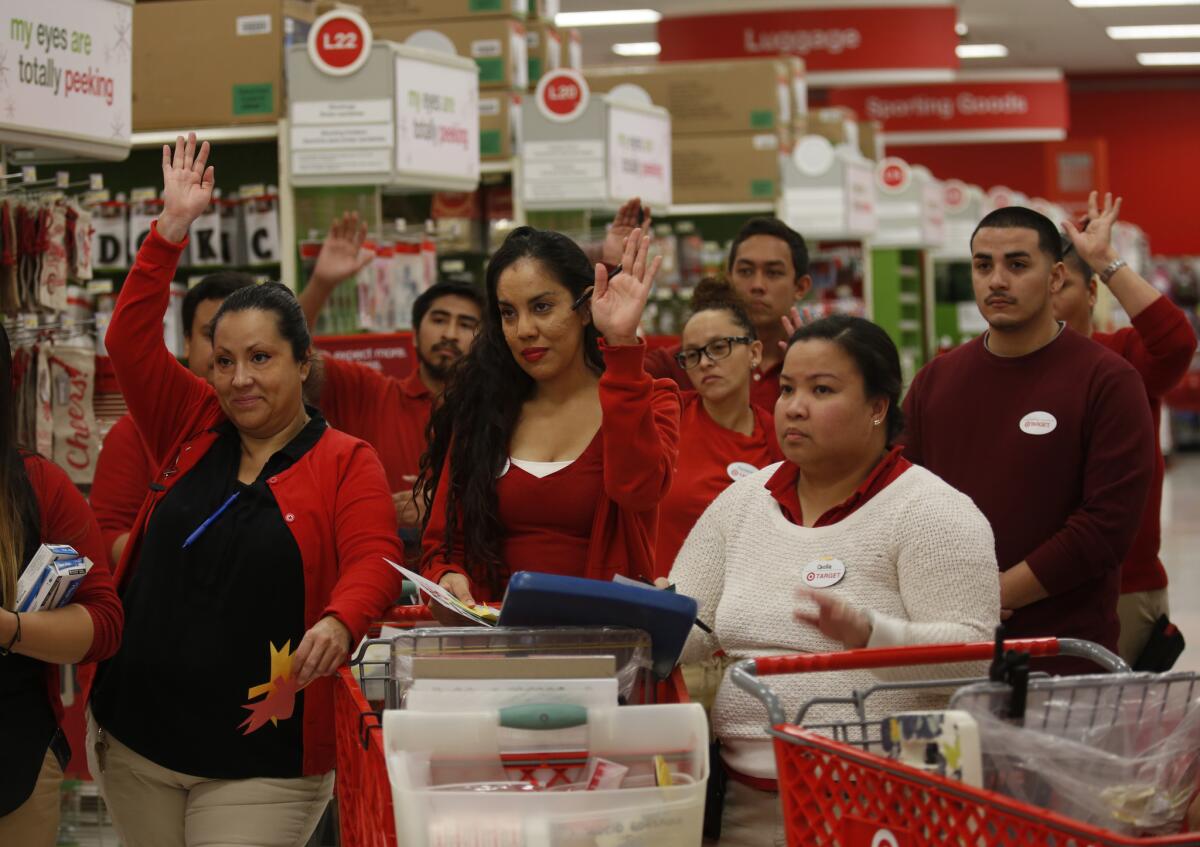 Workers huddle for a meeting in preparation for Black Friday at a Target store in Los Angeles last year.