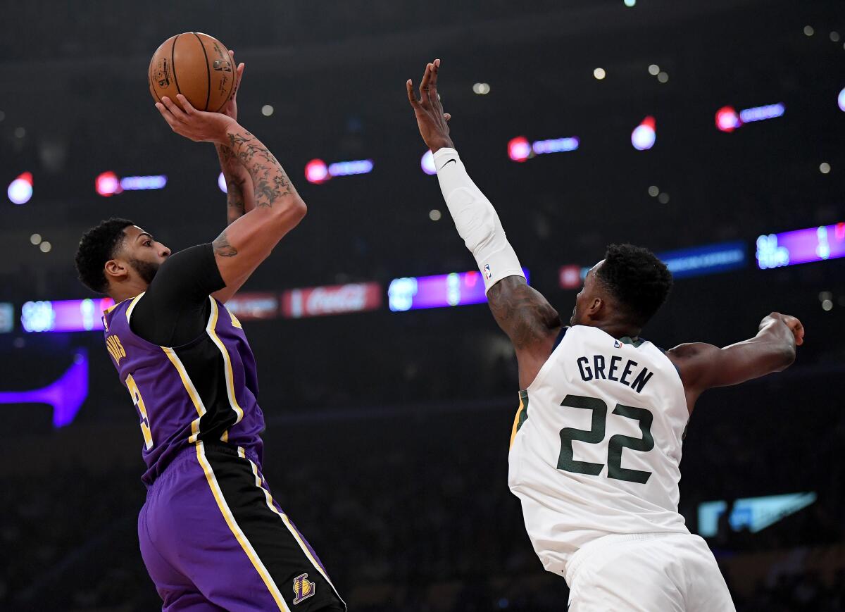 Lakers star Anthony Davis shoots a fadeaway jumper over Utah Jazz forward Jeff Green during the first half of Friday's game.