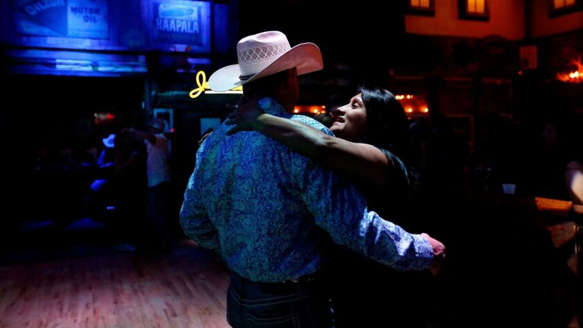 Deedee Jozwika, right, of Houston dances with Jaylon Jacobson of Conroe, Texas, at the Whiskey River Dance Hall & Saloon in Houston on March 23. Conroe, a northern Houston suburb, was the fastest-growing city in the U.S.