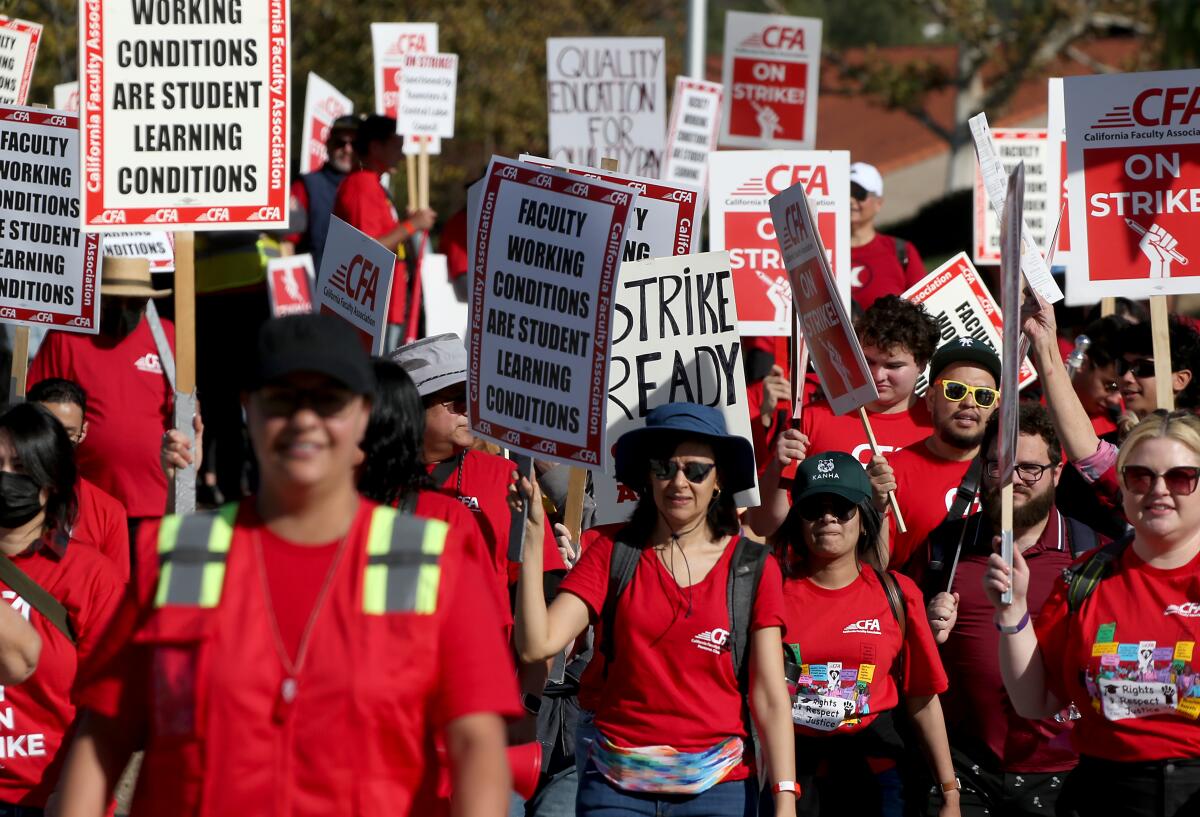 Faculty at Cal Poly Pomona participate in a one-day strike with picket signs.