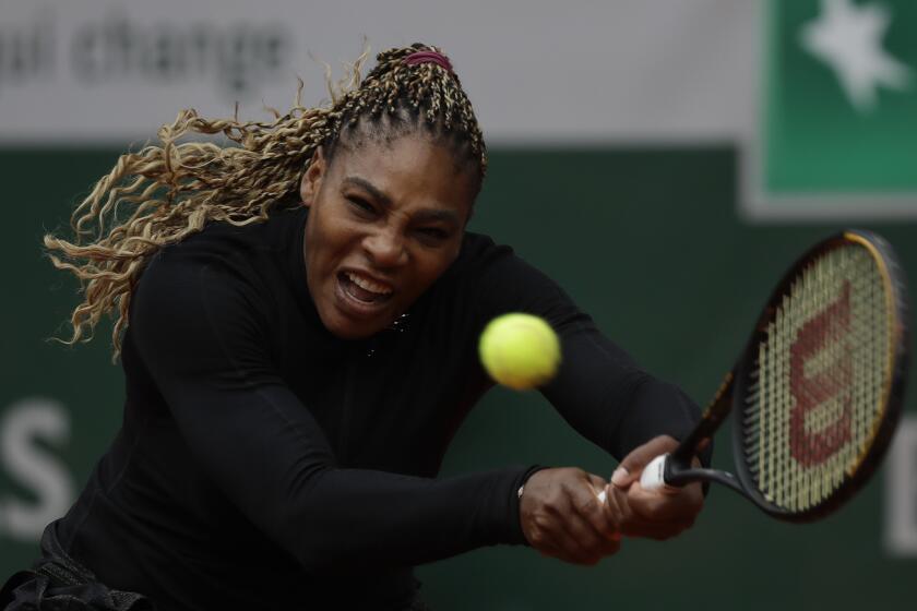 Serena Williams of the U.S. plays a shot against Kristie Ahn of the U.S. in the first round match of the French Open tennis tournament at the Roland Garros stadium in Paris, France, Monday, Sept. 28, 2020. (AP Photo/Alessandra Tarantino)