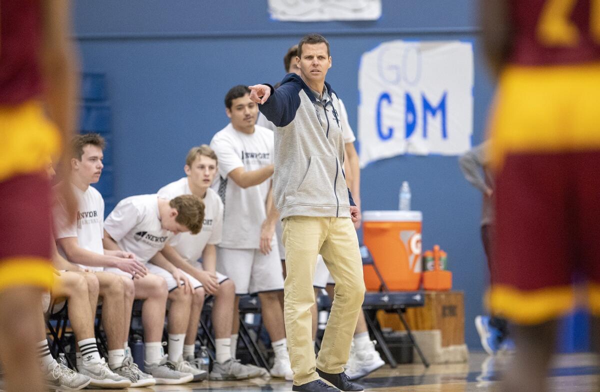 Newport Harbor coach Bob Torribio gives directions to his team in a Coach Mike's Long Shot Challenge game against Riverside Hillcrest on Jan. 21 at Corona del Mar High.