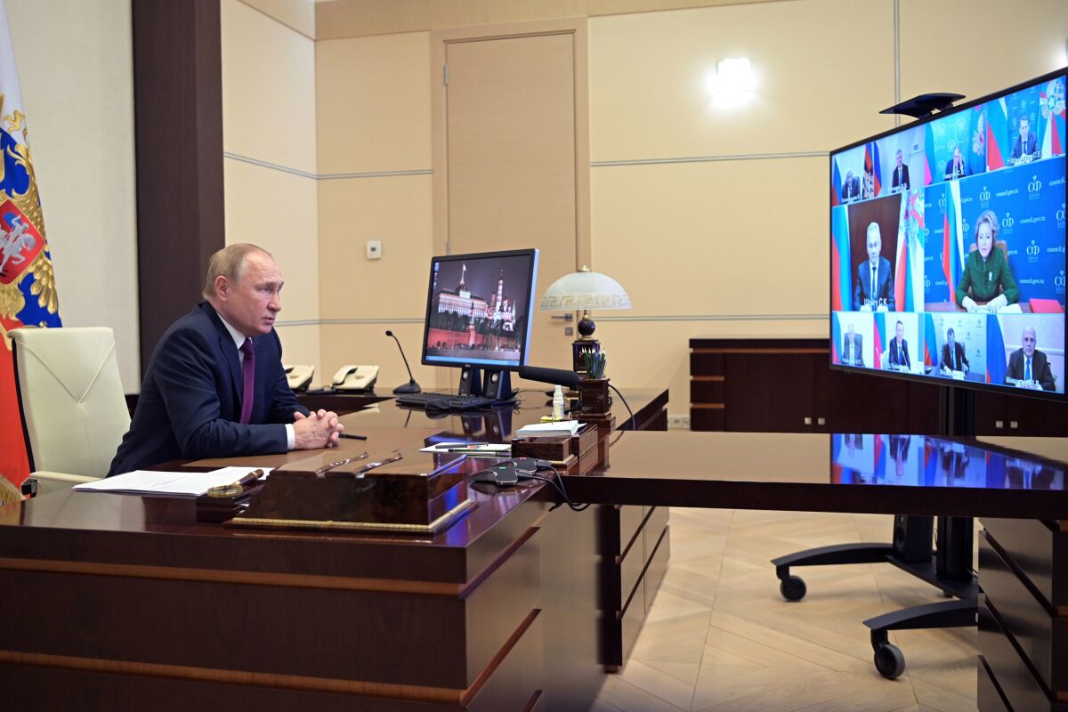 Russian President Vladimir Putin chairs a Security Council meeting via videoconference at the Novo-Ogaryovo residence outside Moscow, Russia, Tuesday, Jan. 11, 2022. (Alexei Nikolsky, Sputnik, Kremlin Pool Photo via AP)