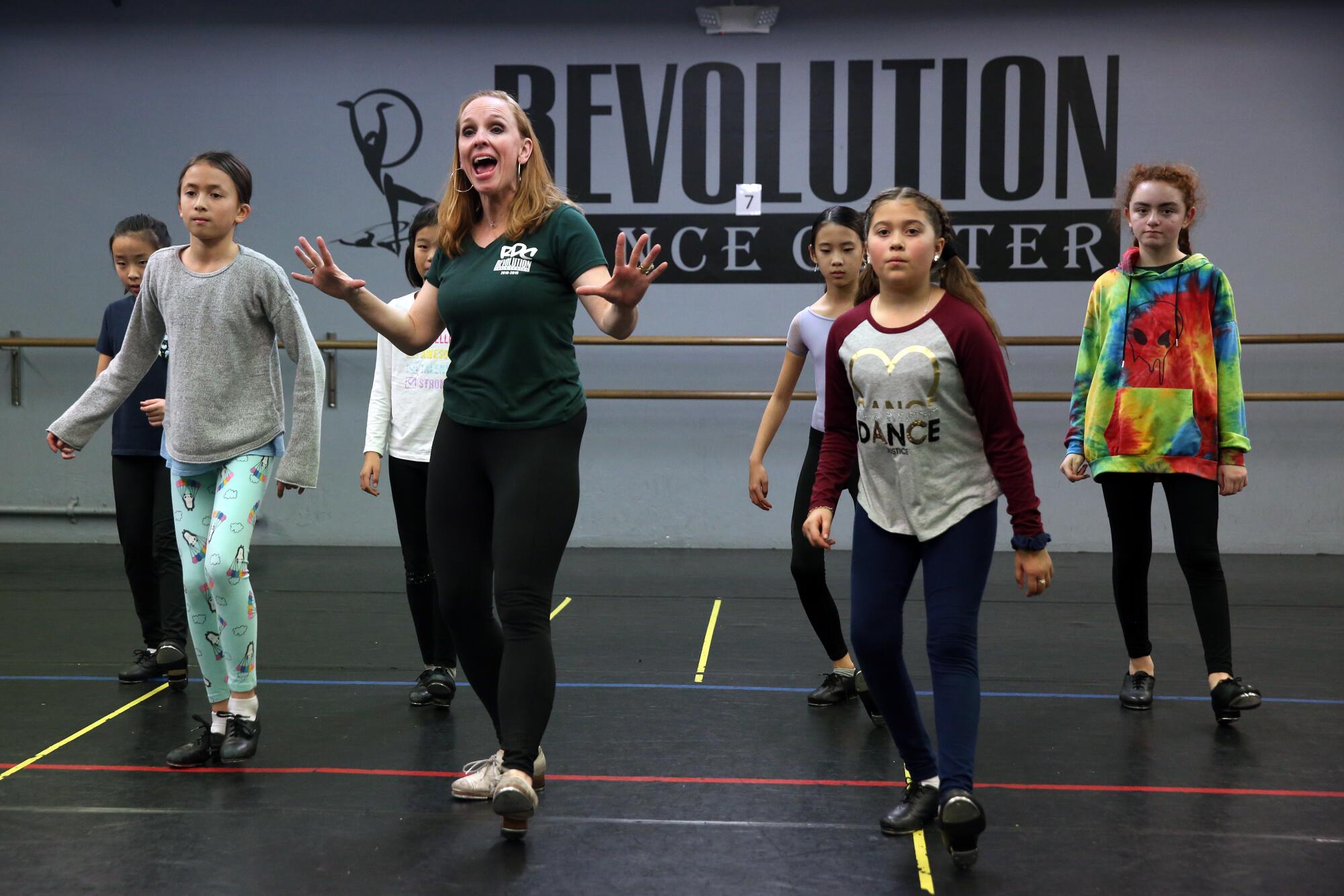 Julie Kay Stallcup leading a group of kids in a tap dance lesson.