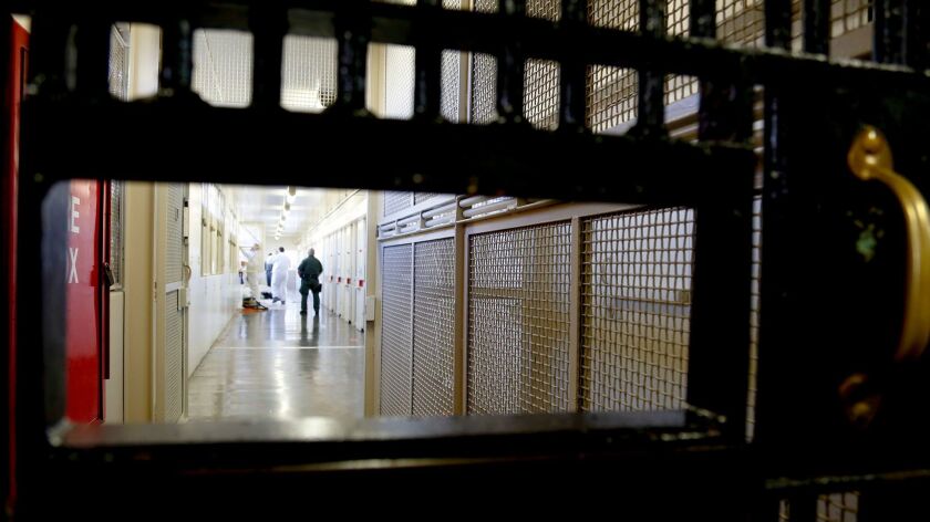A guard watches the hallway at San Quentin State Prison.