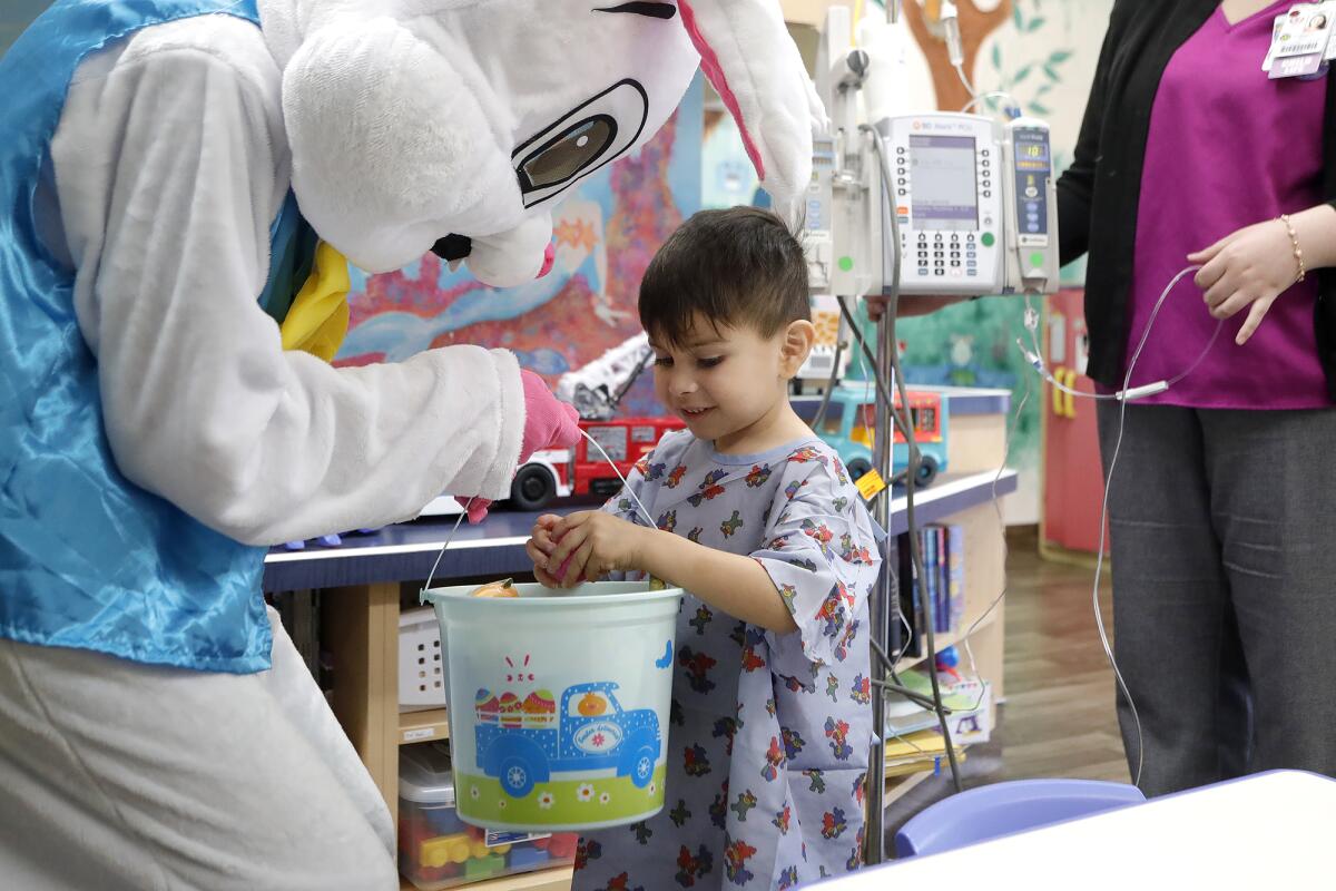 The Easter Bunny visits Aiden Ayala, 4, at Fountain Valley Regional Hospital & Medical Center.