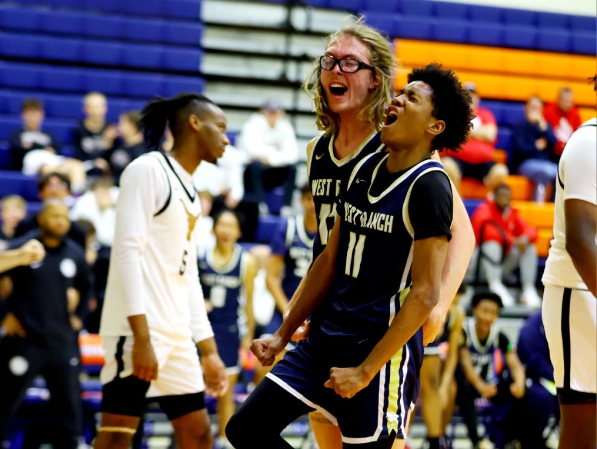 Darrell Morris (11) and Andrew Meadow take a moment to celebrate for unbeaten West Ranch.