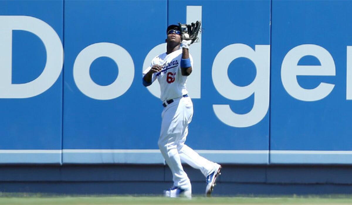 Dodgers outfielder Yasiel Puig catches a fly ball during the fourth inning of the Dodgers' victory over the Chicago Cubs, 4-0, on Wednesday.