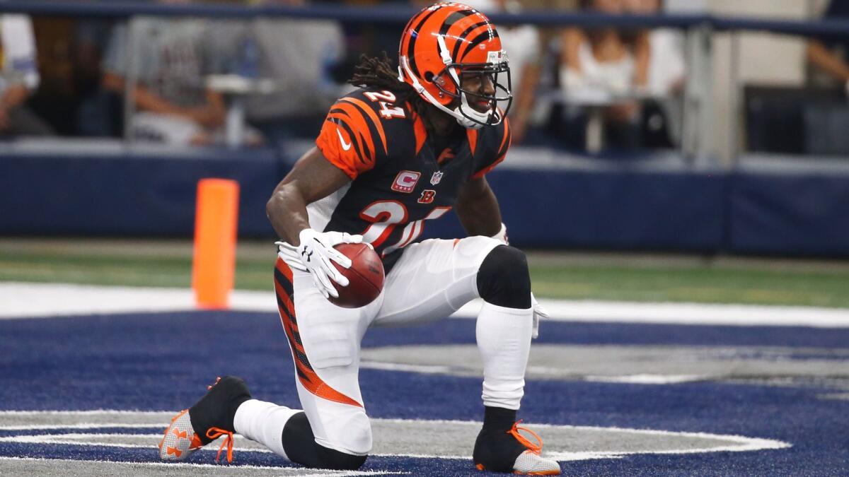 Cincinnati Bengals return man Adam Jones kneels for a touchback after catching a kickoff from the Dallas Cowboys.