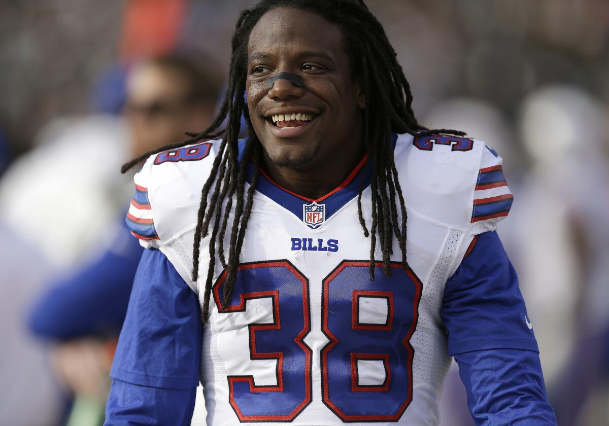 Sergio Brown smiles on the sidelines as he wears a Buffalo Bills uniform with the number 38.