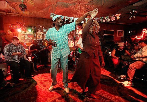 Ellison Coleman, nephew of Big Jack Johnson, dances with his wife, Brenda, at Red's. The juke joint was the home base for the blues legend.