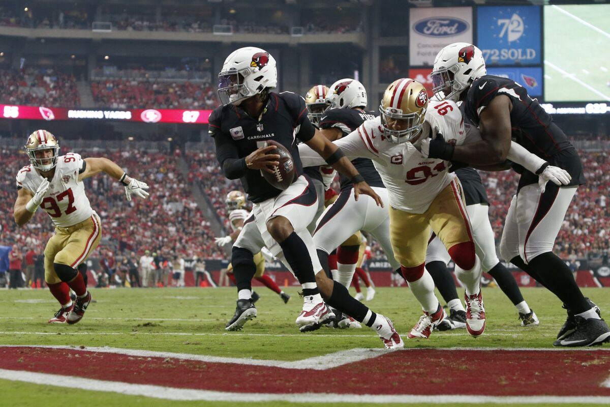 Arizona Cardinals quarterback Kyler Murray (1) eludes the reach of San Francisco 49ers defensive end Arik Armstead (91) during the second half of an NFL football game, Sunday, Oct. 10, 2021, in Glendale, Ariz. (AP Photo/Ralph Freso)