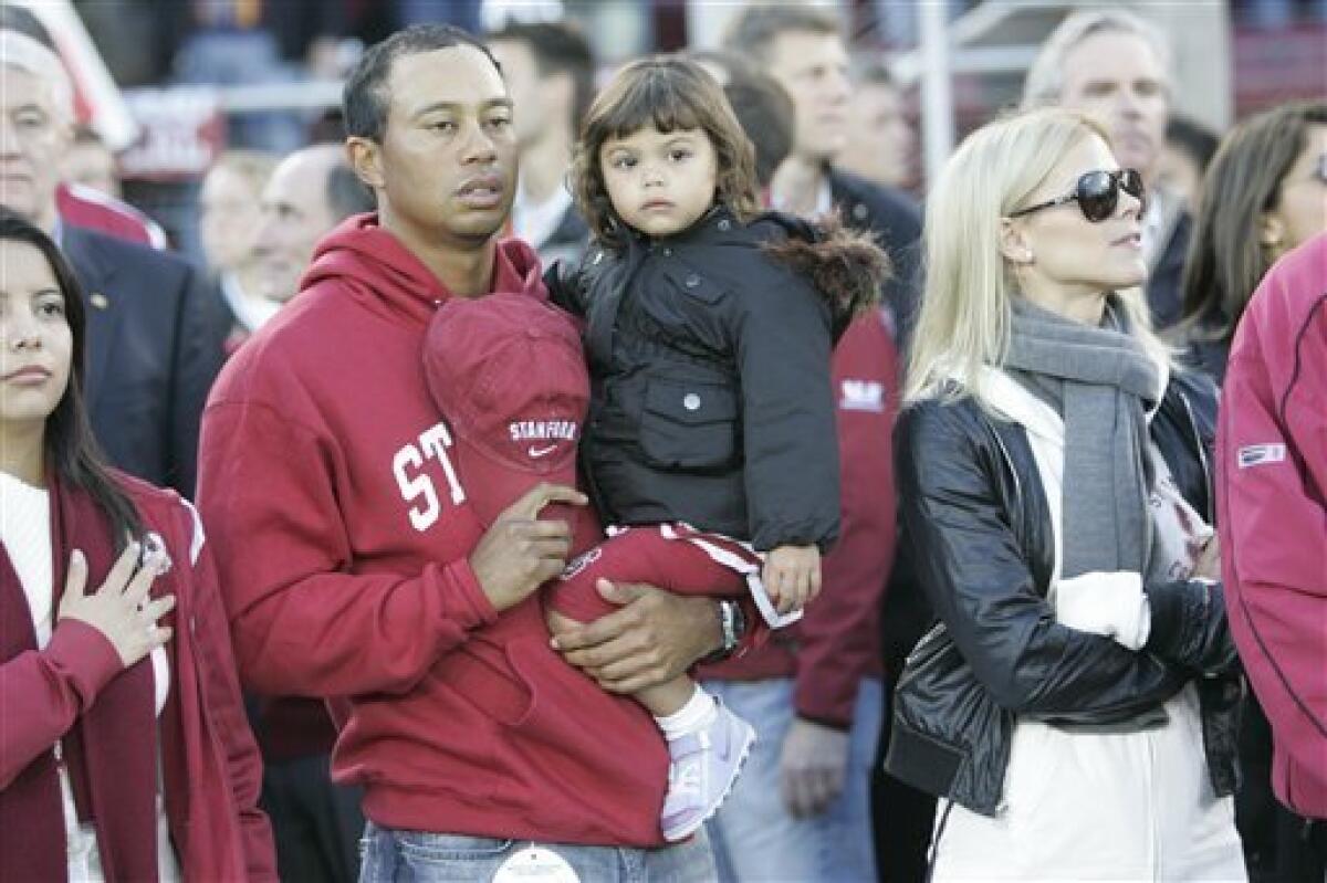 This photo taken Nov. 21, 2009 shows Tiger Woods, his daughter Sam Woods and wife Elin Nordegren, before a NCAA college football game in Stanford, Calif. Woods and his wife are officially divorced. The lawyers for Woods and Nordegren said in a statement that the divorce became official Monday Aug. 23, 2010, in Bay County Circuit Court, in Panama City, Fla. (AP Photo/Marcio Jose Sanchez)
