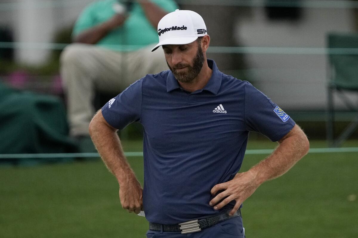 Dustin Johnson looks down after putting on the 18th hole during the second round of the Masters golf tournament on Friday, April 9, 2021, in Augusta, Ga. (AP Photo/Gregory Bull)