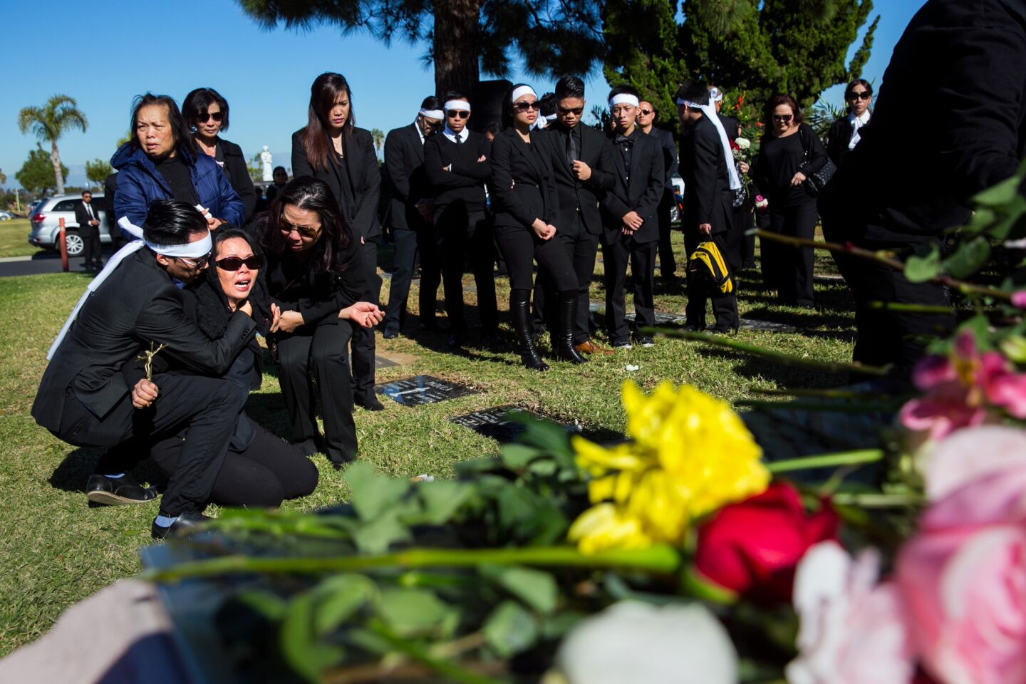 Van Thanh Nguyen shouts her daughter's name during her funeral at the Good Shepherd Cemetary in Huntington Beach. Tin Nguyen was 31.