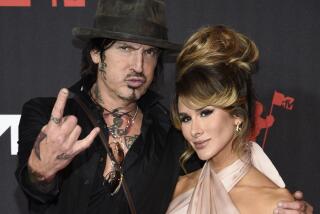 Tommy Lee, left, and Brittany Furlan arrive at the MTV Video Music Awards on Sept. 12, 2021, in New York