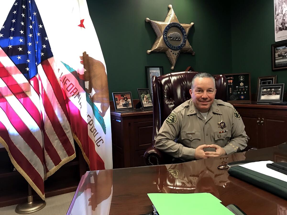 L.A. County Sheriff Alex Villanueva sits at a desk