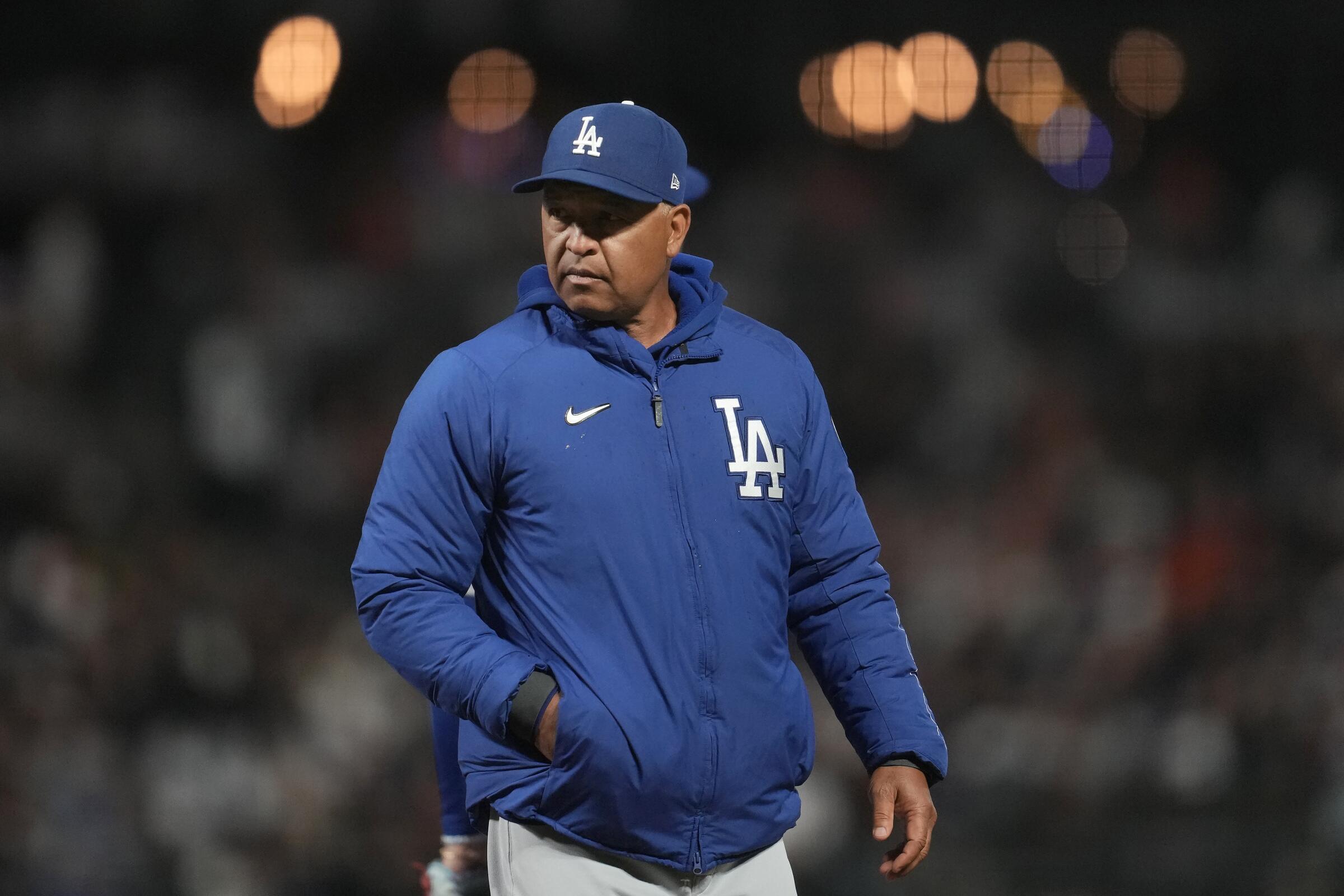 Los Angeles Dodgers manager Dave Roberts walks to the dugout after making a pitching change.