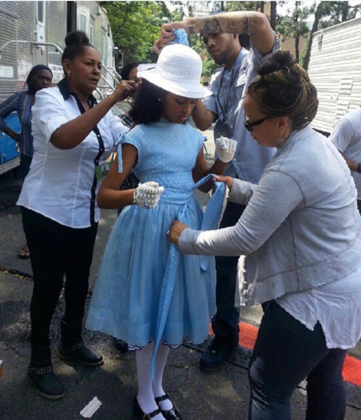 Ruth E. Carter, right, dressing one of the girls for the church bombing scene in "Selma" on set.