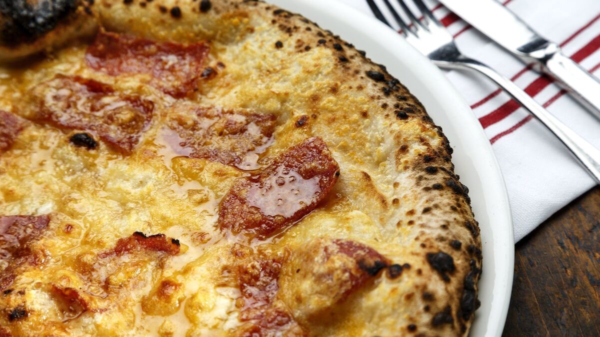 Steve Samson might be known best for the leopard-spotted pies at Sotto. Pictured is a pizza topped with spicy salami and honey.