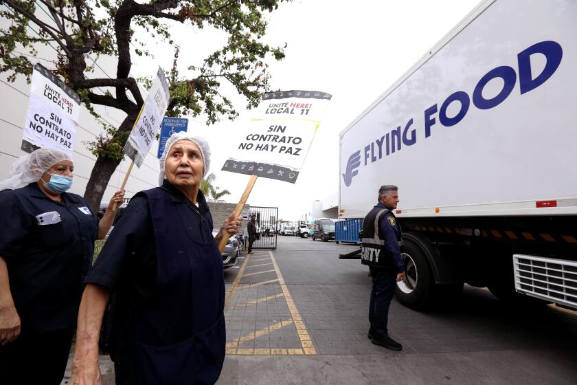 INGLEWOOD, CA - MAY 22, 2024 - Salud Garcia, 80, second from left, who works with a catering service called Flying Food Group, walks the picket line with fellow workers, with the help of Unite Here Local 11, in front of Flying Food Group in Inglewood on May 22, 2024. Garcia has worked at the place for 30 years. She's fighting for better wages and better working conditions and wants to keep at it until there's a better contract in place for younger families. (Genaro Molina/Los Angeles Times)