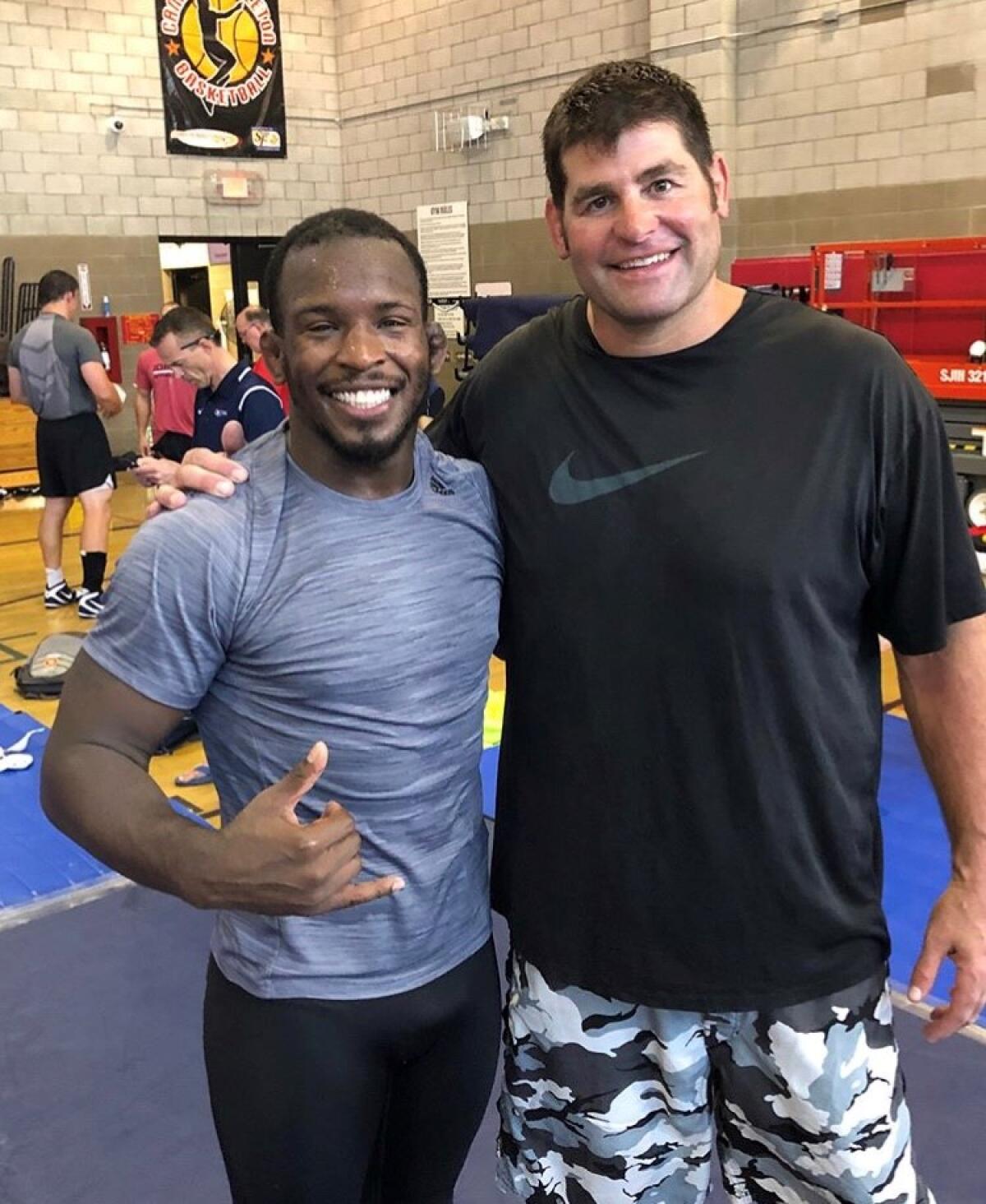 Rich Perry poses with Stephen Neal in 2018 during a USA Wrestling training camp at Camp Pendelton, two days before his injury