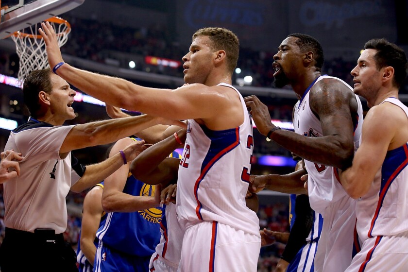 Clippers power forward Blake Griffin steps between teammate DeAndre Jordan, who is being held back by guard J.J. Redick, and Warriors center Andrew Bogut (not pictured) after a hard foul led to an altercation in the second quarter.