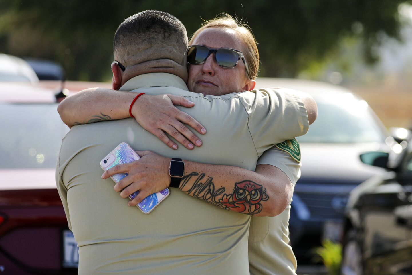 San Bernardino National Forest officer Mark Munoz Jr., left, and Samantha Gardner embrace