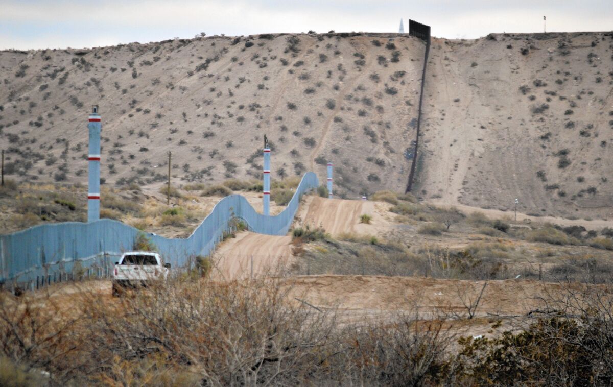 A U.S. Border Patrol agent drives near the U.S.-Mexico border fence in Sunland Park, N.M.