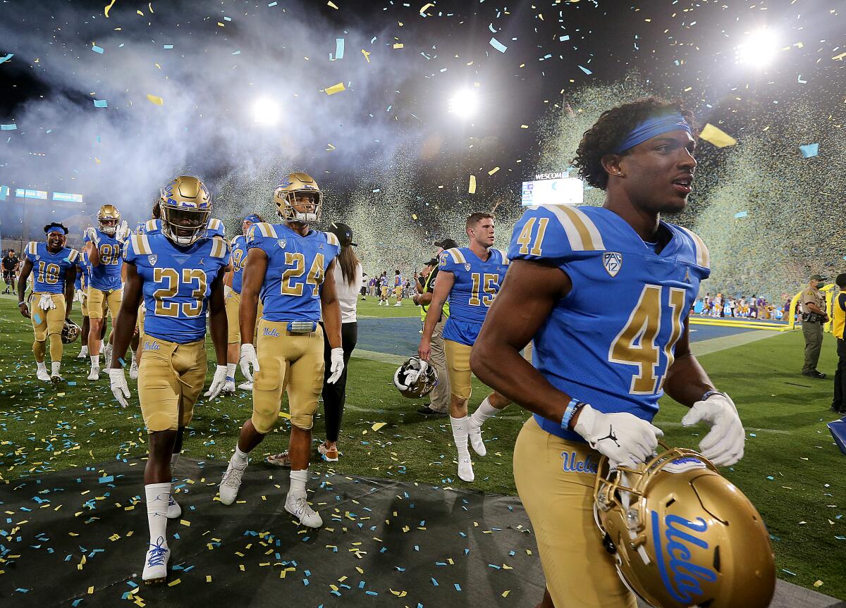 UCLA players leave the field at the Rose Bowl after beating LSU 38-27 on Saturday.