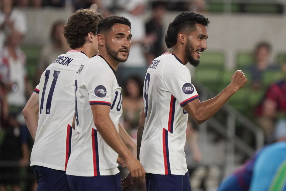 U.S. forward Jesus Ferriera, right, celebrates his fourth goal against Grenada with Cristian Roldan (10) and Brenden Aaronson (11) during the second half of a CONCACAF Nations League soccer match in Austin, Texas, Friday, June 10, 2022. (AP Photo/Chuck Burton)