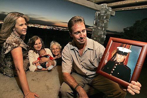 At their favorite park table above the city of Albuquerque, the family of Chris Adlesperger recalls a lifetime of picnics and parties before he was killed in Iraq. From left: his aunt, Casy; cousin, Tamara, with her son, Christopher; grandmother, Wanda; and father, Gary, holding a portrait of his son in his Marine uniform.