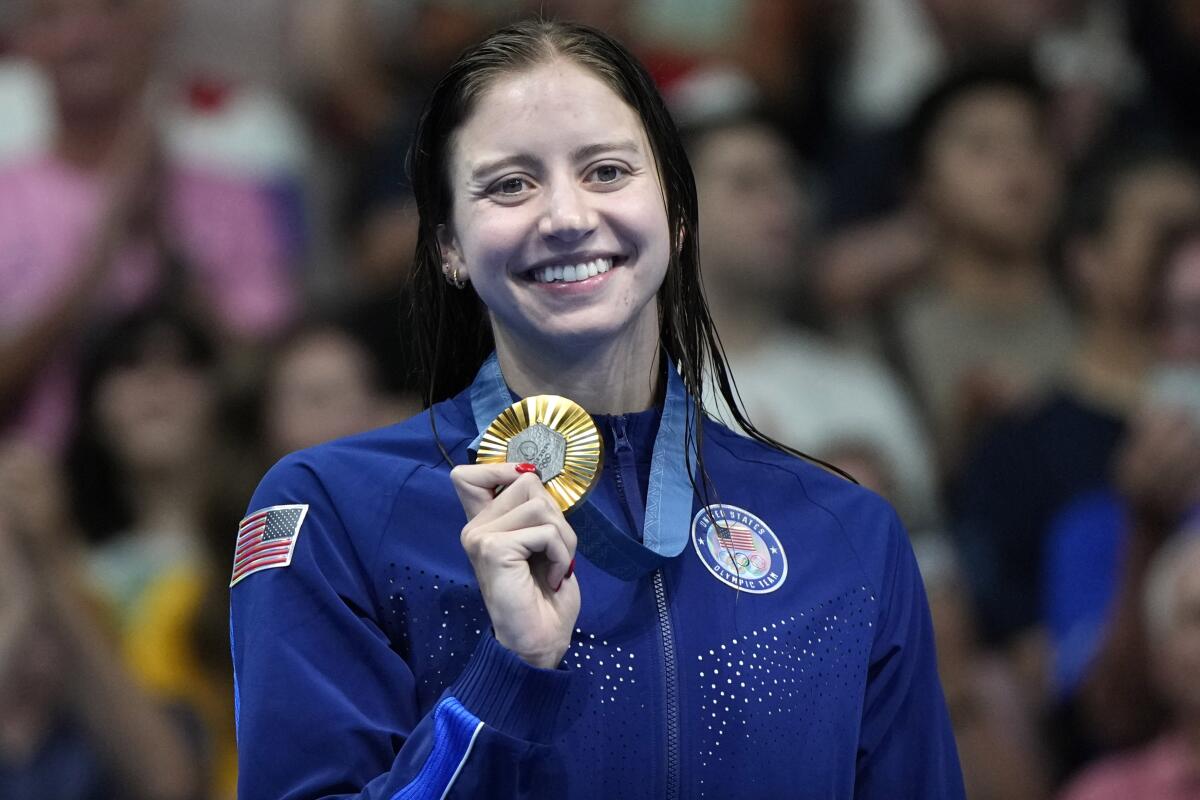 Kate Douglass poses for a photo with her gold medal in the women's 200-meter breaststroke final Thursday.