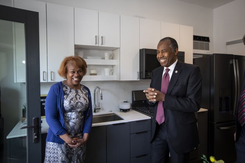 LOS ANGELES, CALIF. - FEBRUARY 13: Secretary Ben Carson, right, takes a tour of a garage converstion in Felicia Smith’s yard in Los Angeles, Calif. on Thursday, Feb. 13, 2020. Carson was speaking at a conference at USC and then will be touring an Accessory Dwelling Unit. (Francine Orr / Los Angeles Times)