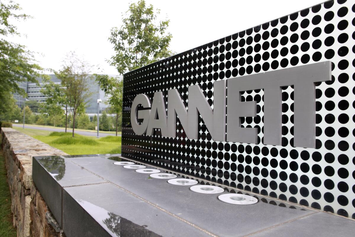 A sign with the word Gannet on it is outside its headquarters. 